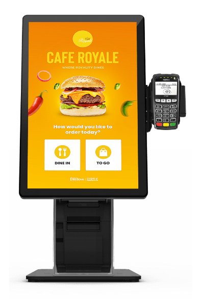 A floor-standing self-ordering kiosk for Cafe Royale, showcasing a bright yellow burger-themed interface with dine-in and to-go options and a card reader attached.