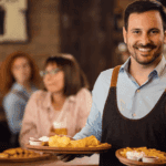 Smiling restaurant server delivering food to happy guests in a casual dining setting, representing improved customer experience with Applova’s email marketing tools.