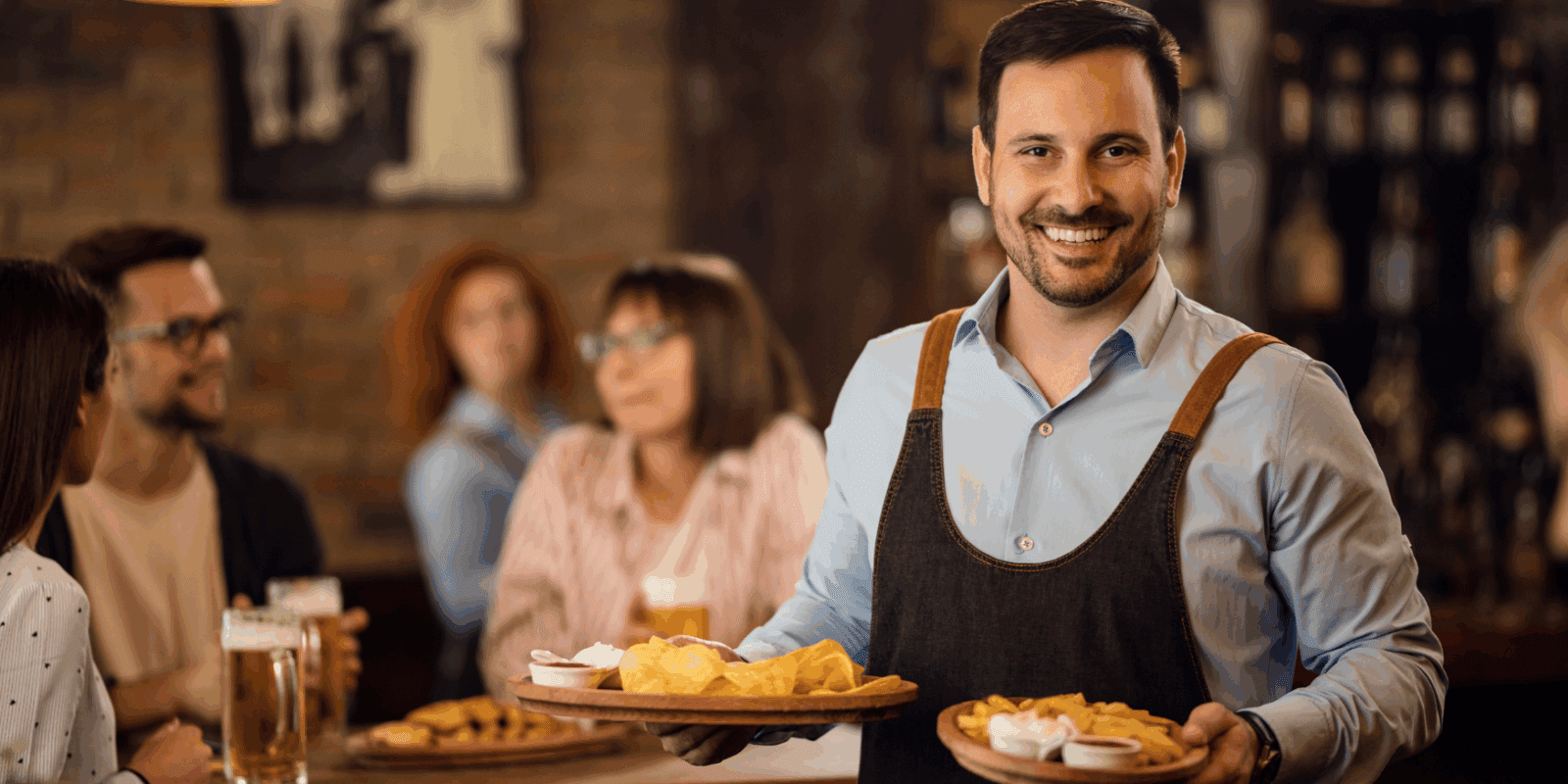 Smiling restaurant server delivering food to happy guests in a casual dining setting, representing improved customer experience with Applova’s email marketing tools.