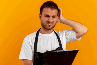 Restaurant staff member looking confused while reviewing operational checklist or inventory