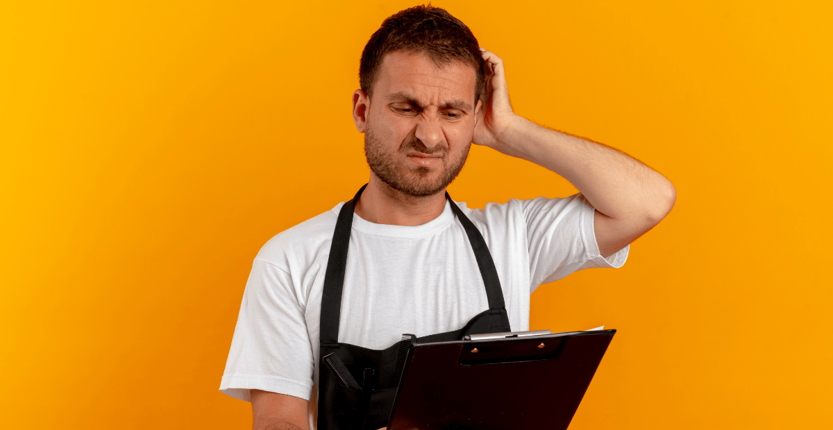Restaurant staff member looking confused while reviewing operational checklist or inventory